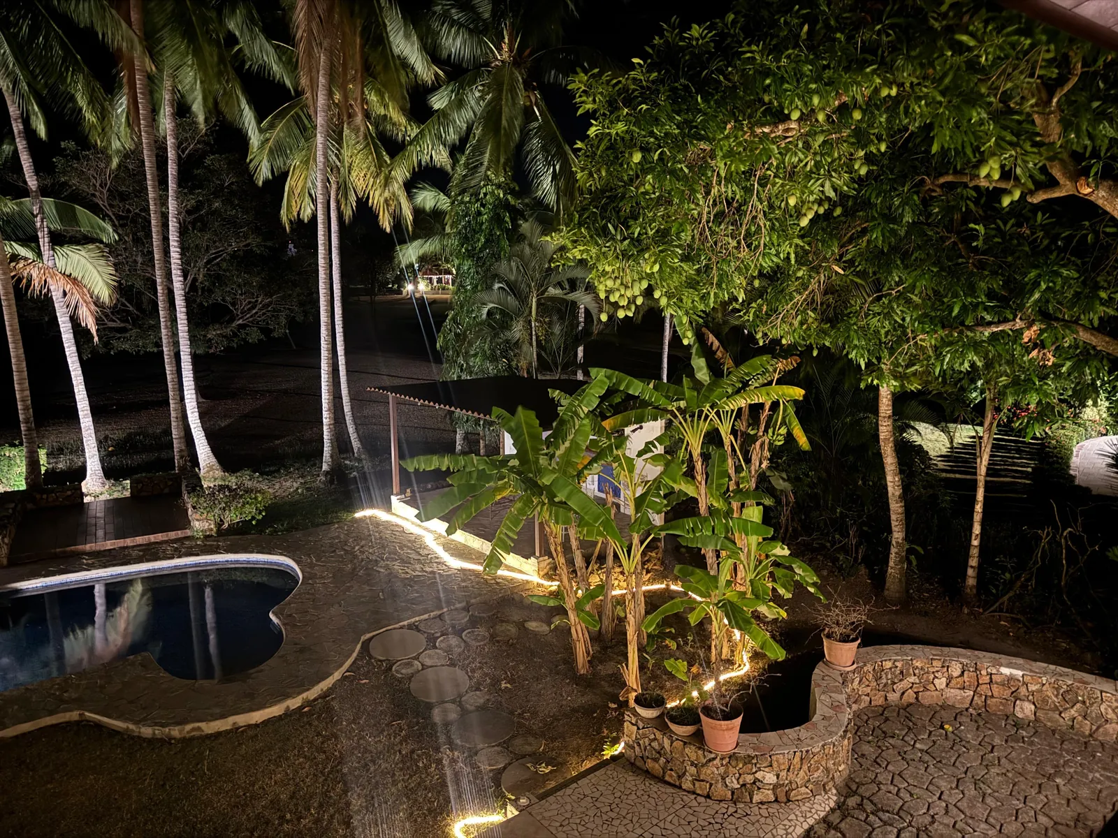 Gardens lit at night — Spanish Colonial home for sale at Coronado Golf Club, Panama