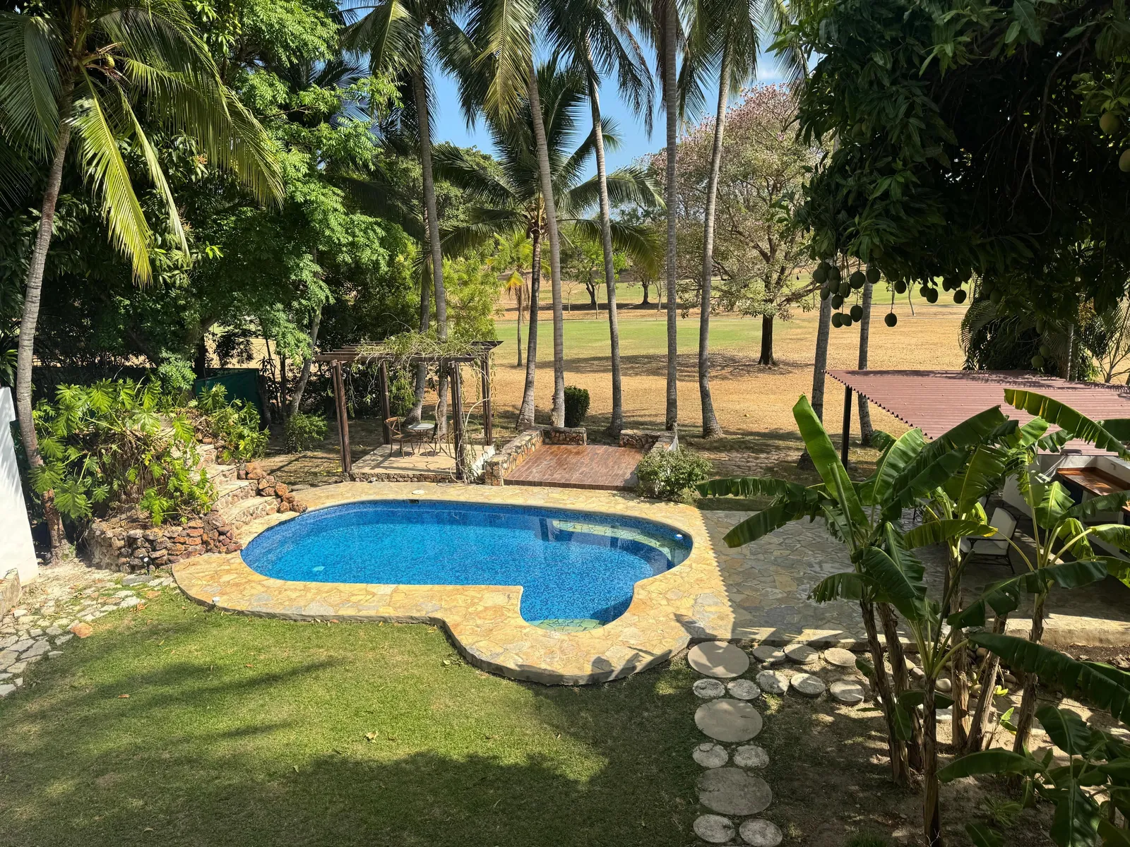 Pool, lawn and the golf course — Spanish Colonial home for sale at Coronado Golf Club, Panama