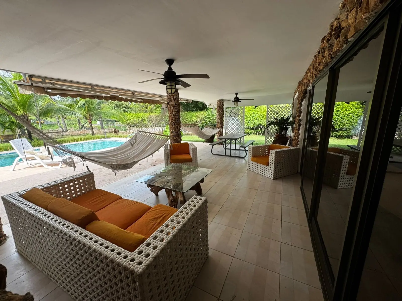 The pool and covered terrace — lakeside home for sale at Club Ecuestre de Coronado, Panama