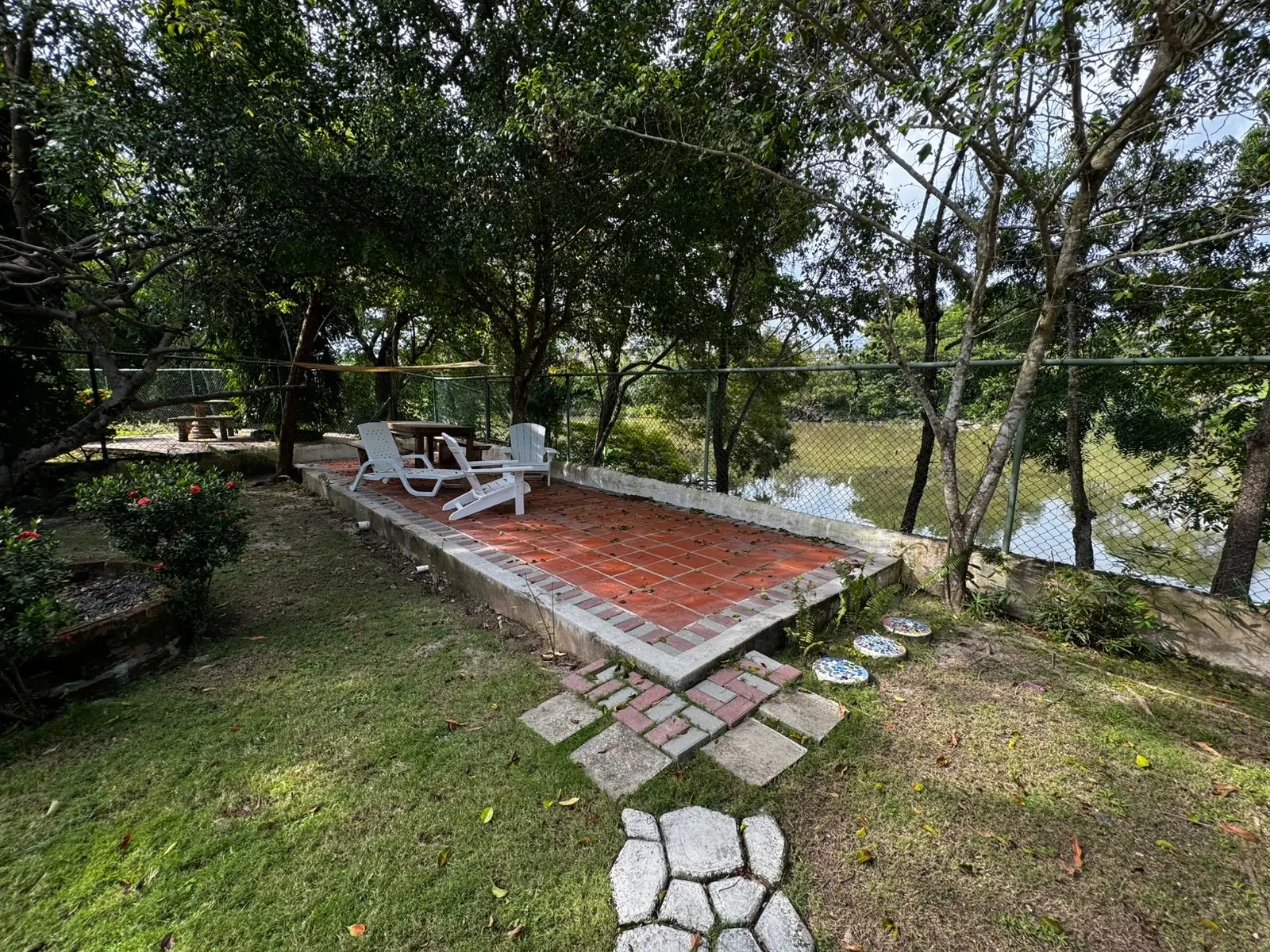 Brick terrace at the bottom of the garden — lakeside home for sale at Club Ecuestre de Coronado, Panama