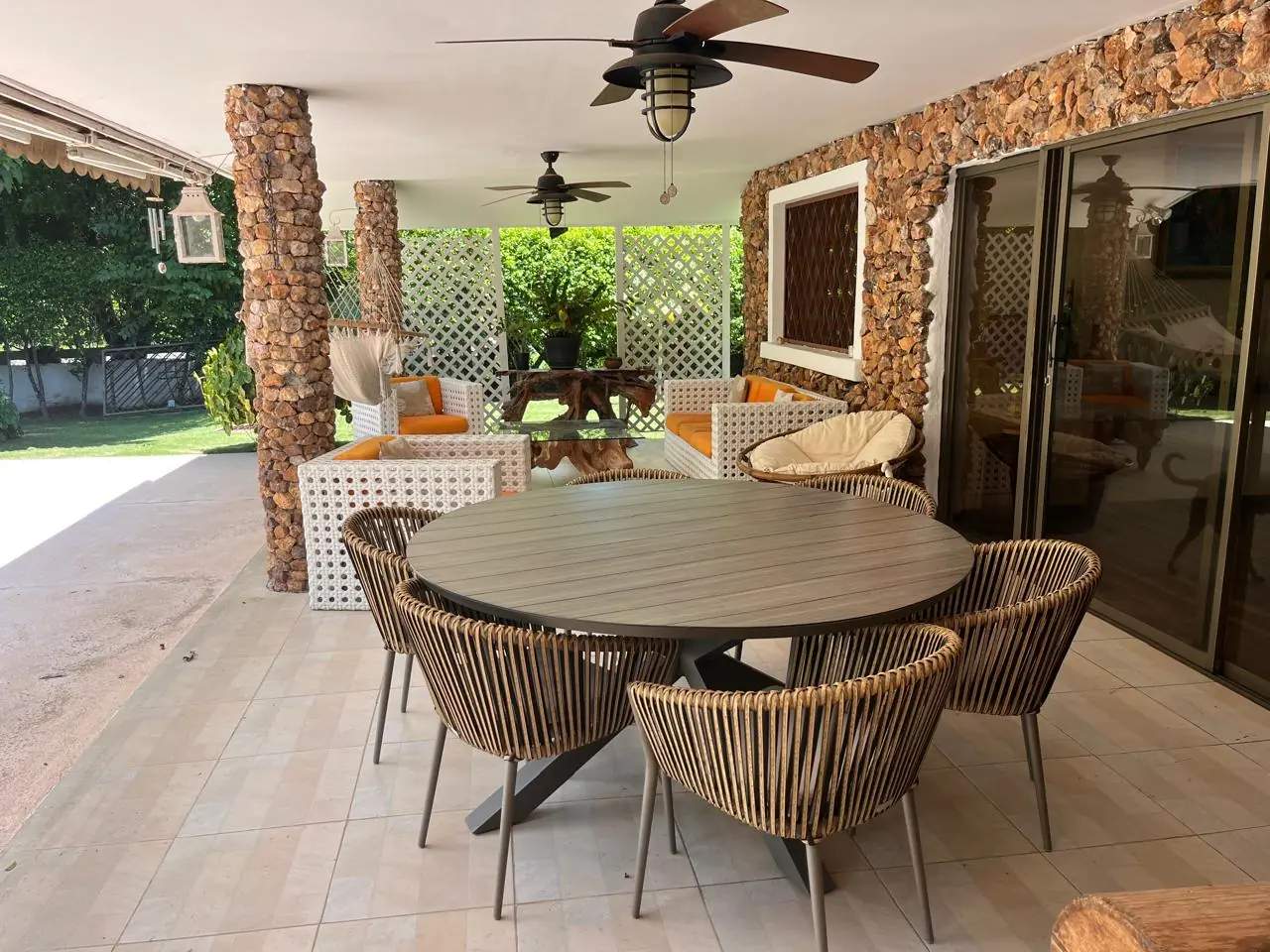 The terrace looking out to the garden — lakeside home for sale at Club Ecuestre de Coronado, Panama