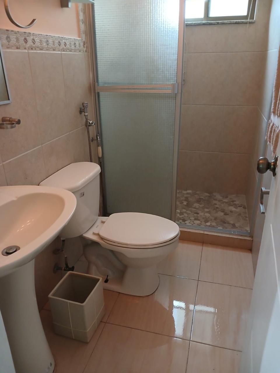 Second bathroom with shower and pedestal sink