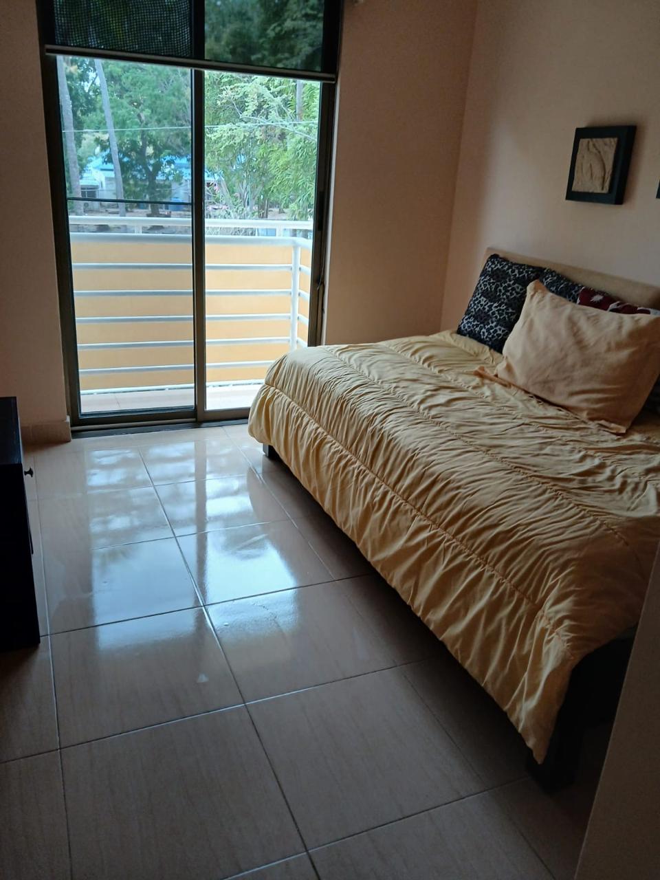 Second bedroom with queen-size bed and balcony access