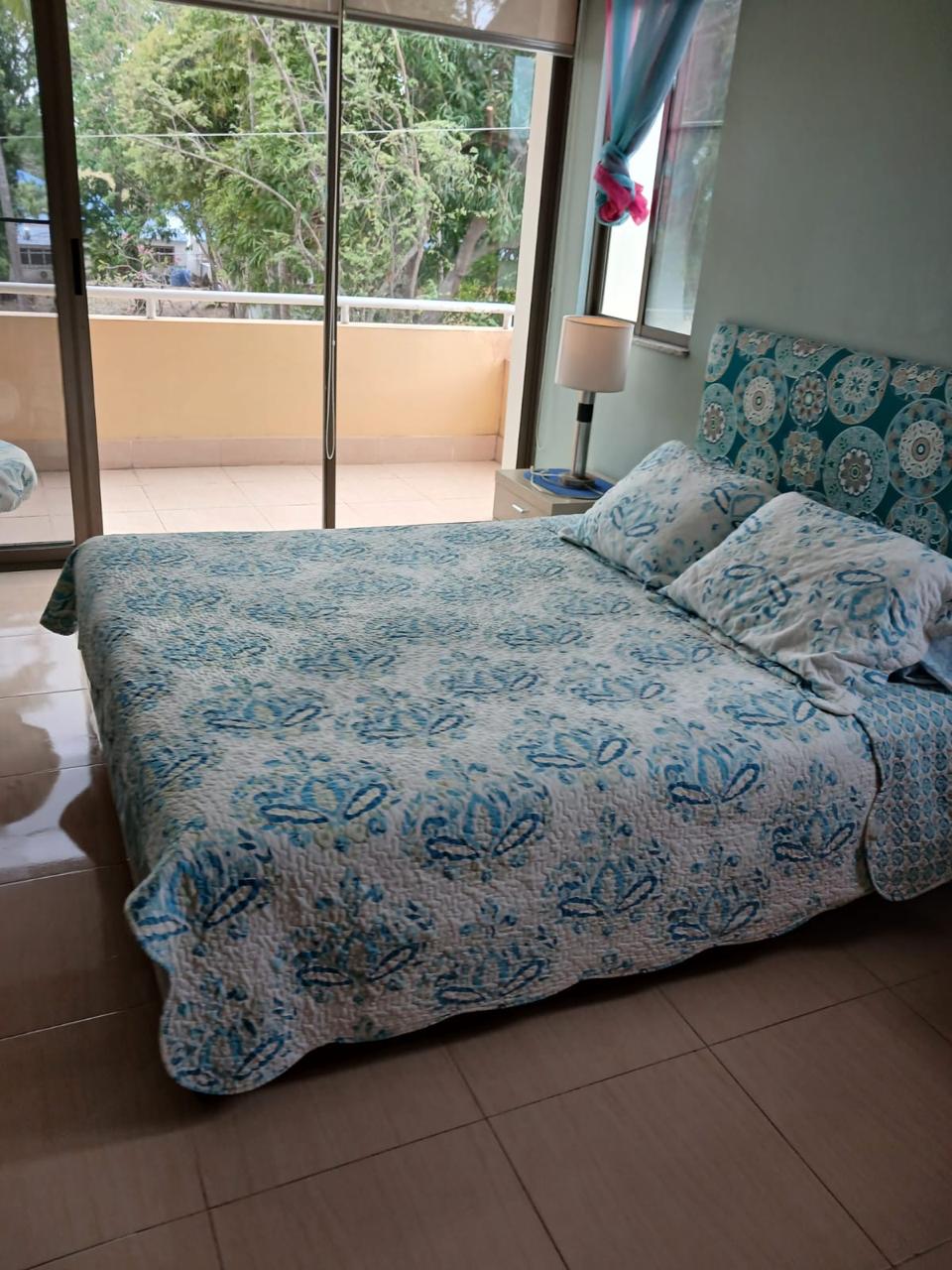 Master bedroom with king-size bed and balcony