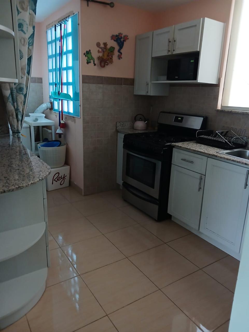 Kitchen with gas range, granite counters, and microwave