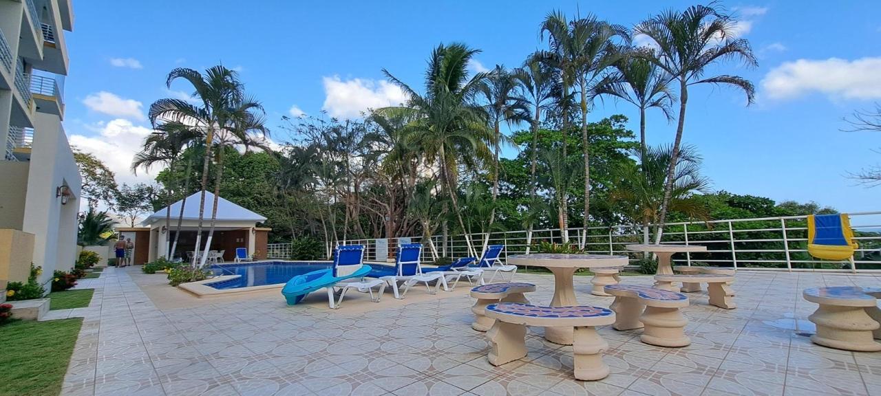 Pool and palm-lined common area at Gorgona OceanFront