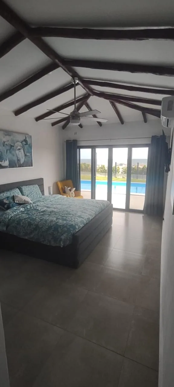 Bedroom opening onto the pool — ocean-view home for sale in Terrazas de Vista Mar, San Carlos, Panama