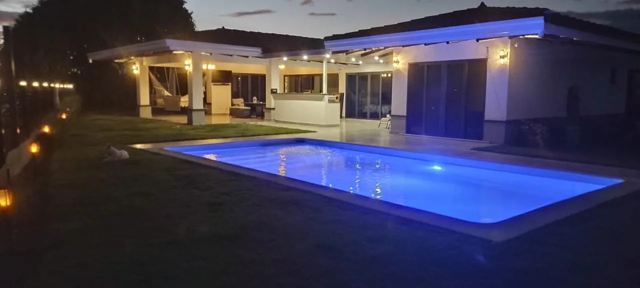 The covered patio and pool at night — ocean-view home for sale in Terrazas de Vista Mar, San Carlos, Panama
