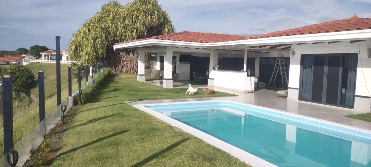 Pool, lawn and covered terrace — ocean-view home for sale in Terrazas de Vista Mar, San Carlos, Panama